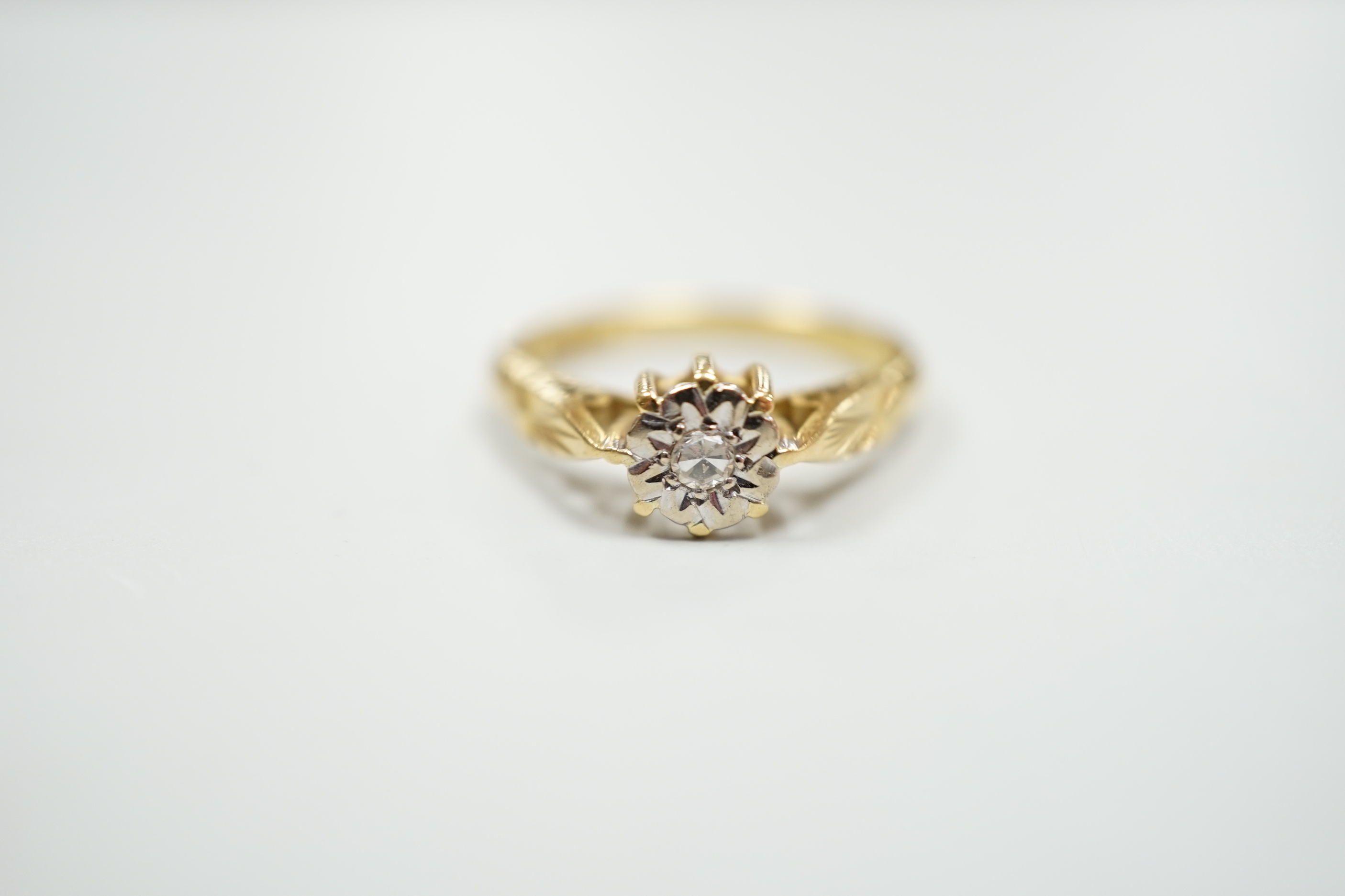 Six assorted gold dress rings, comprising an 18ct gold and platinum three stone ring, size O, an 18ct gold claw set solitaire diamond ring, size O, an 18ct gold illusion set solitaire diamond ring, size L, an 18ct gold t